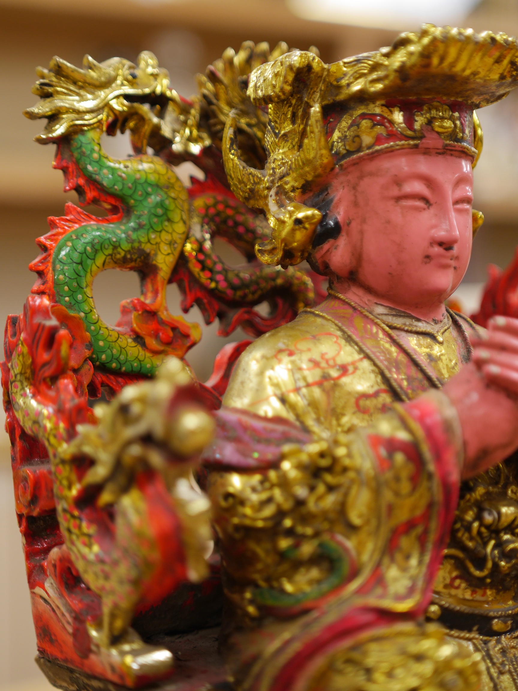 A Chinese gilt and painted composition figure of a seated immortal, 31cm tall. Condition - poor to fair